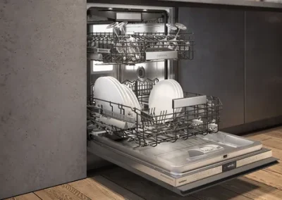Gaggenau built-in dishwasher open with loaded racks in a modern kitchen